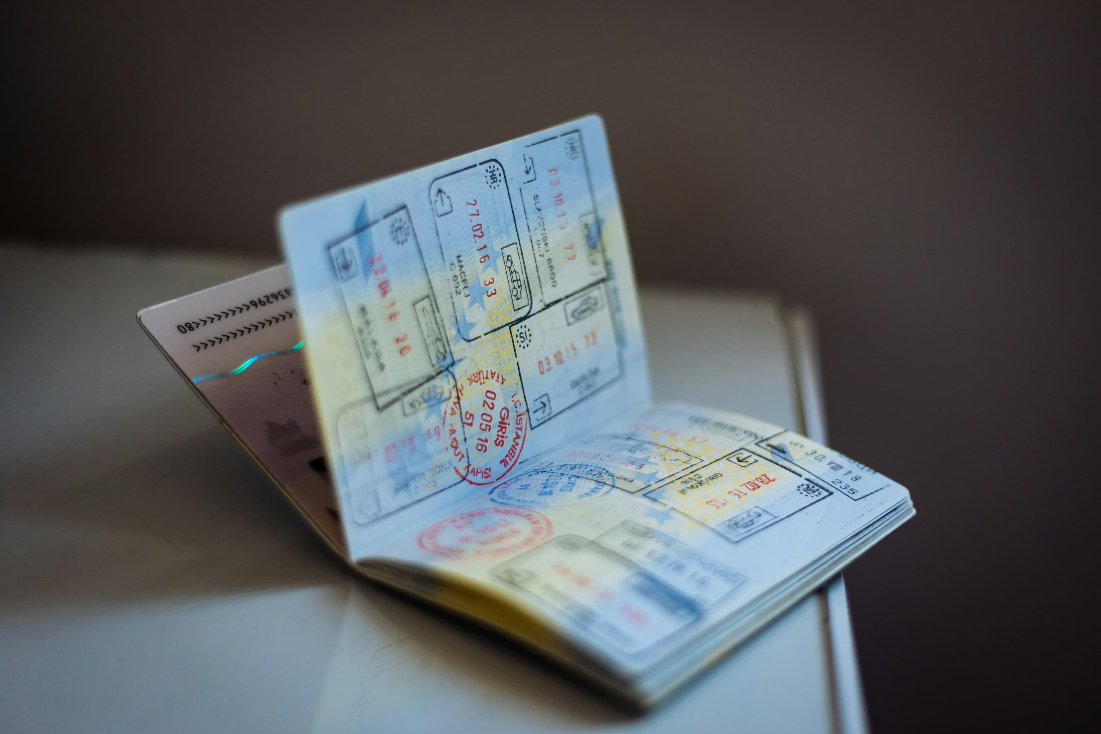 Open passport with entry and exit visa stamps