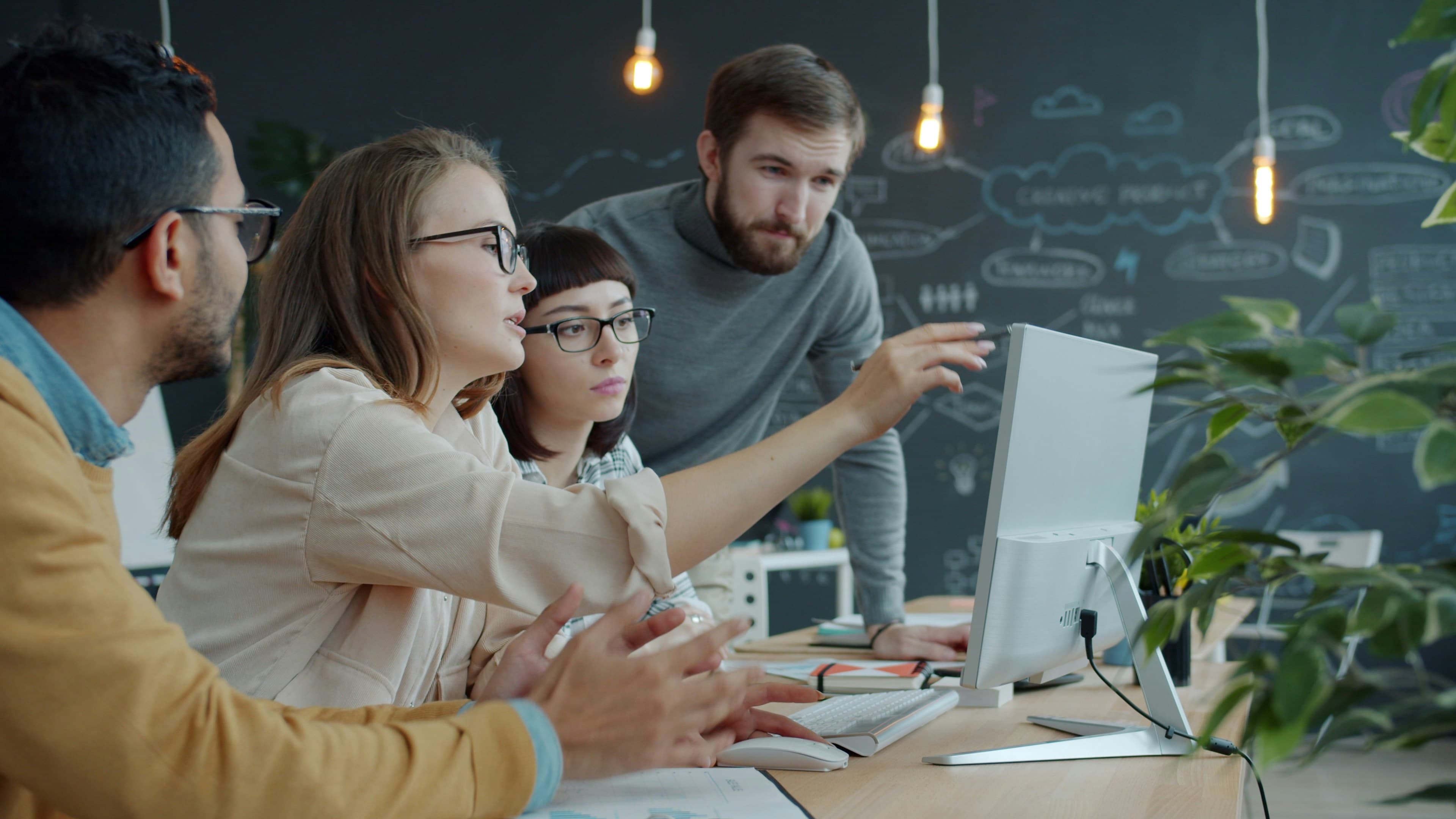 Team working together at a computer in a modern office