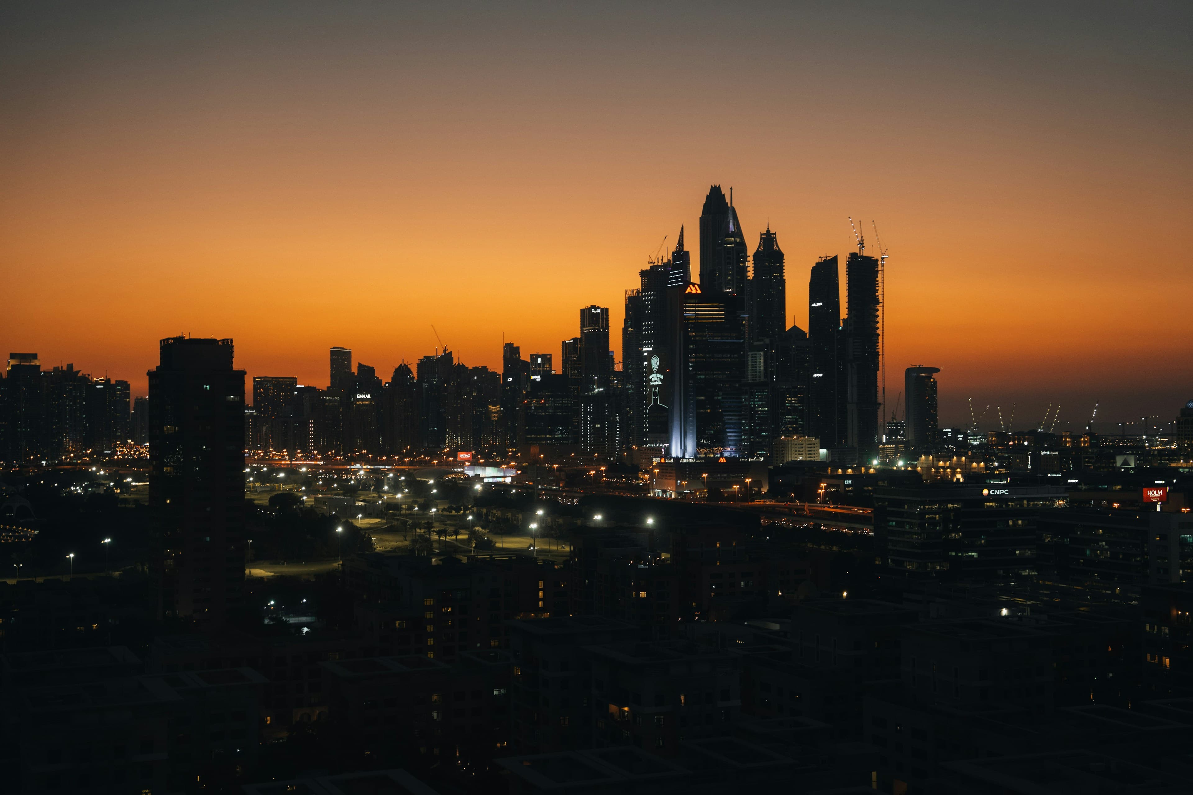 Dubai Marina skyline silhouetted against an orange sunset